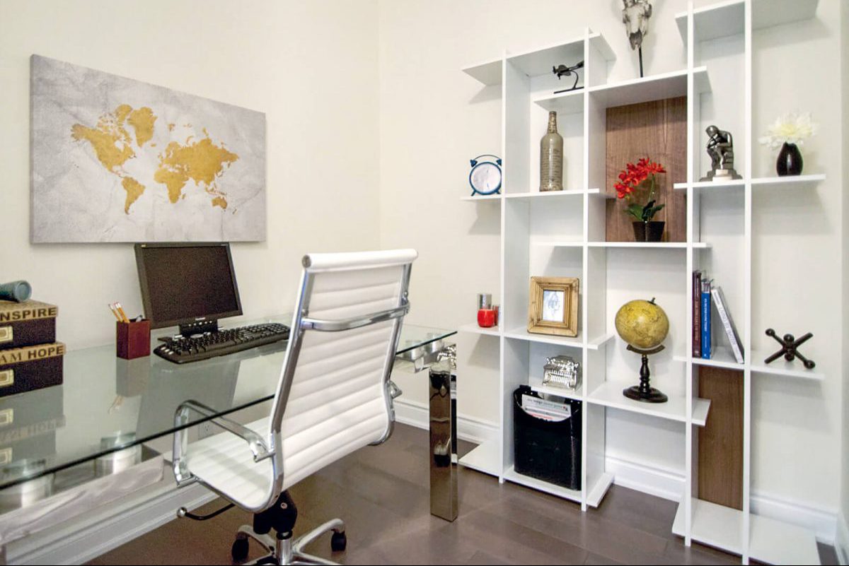 Glass desk with white office chair and white bookshelf