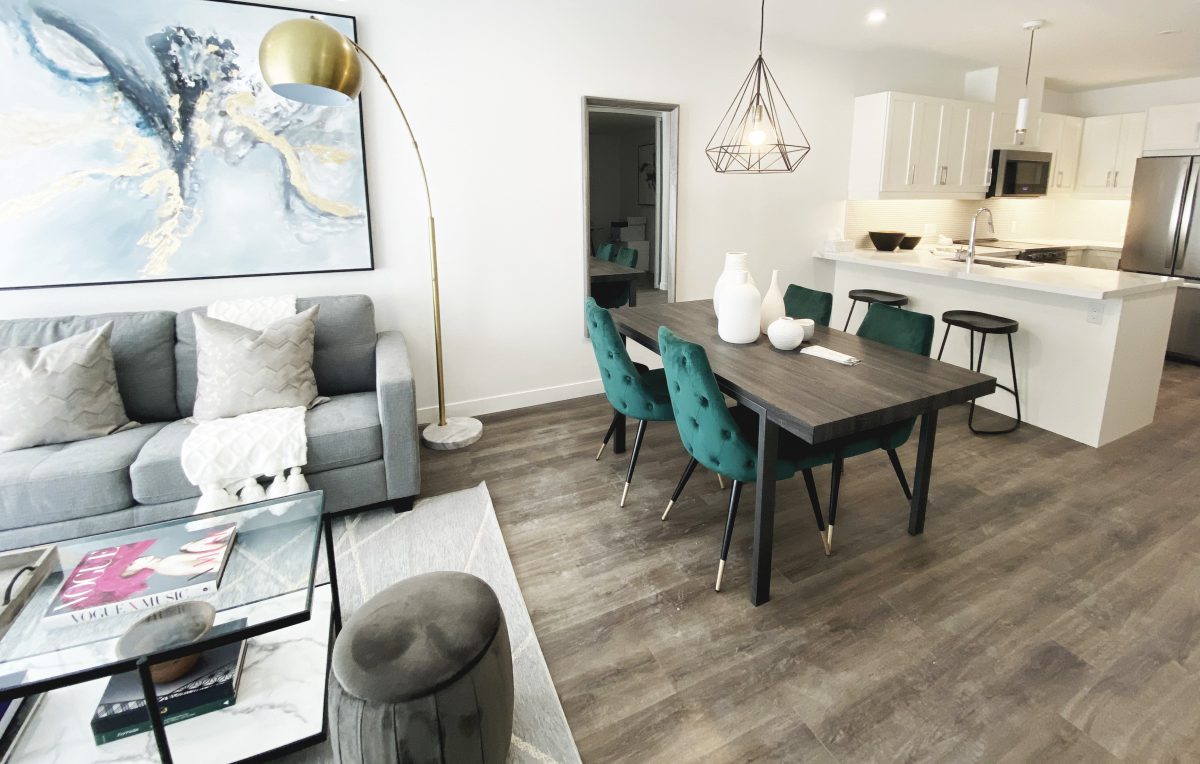 Contemporary dining room with walnut dining table and tufted velvet green dining chairs