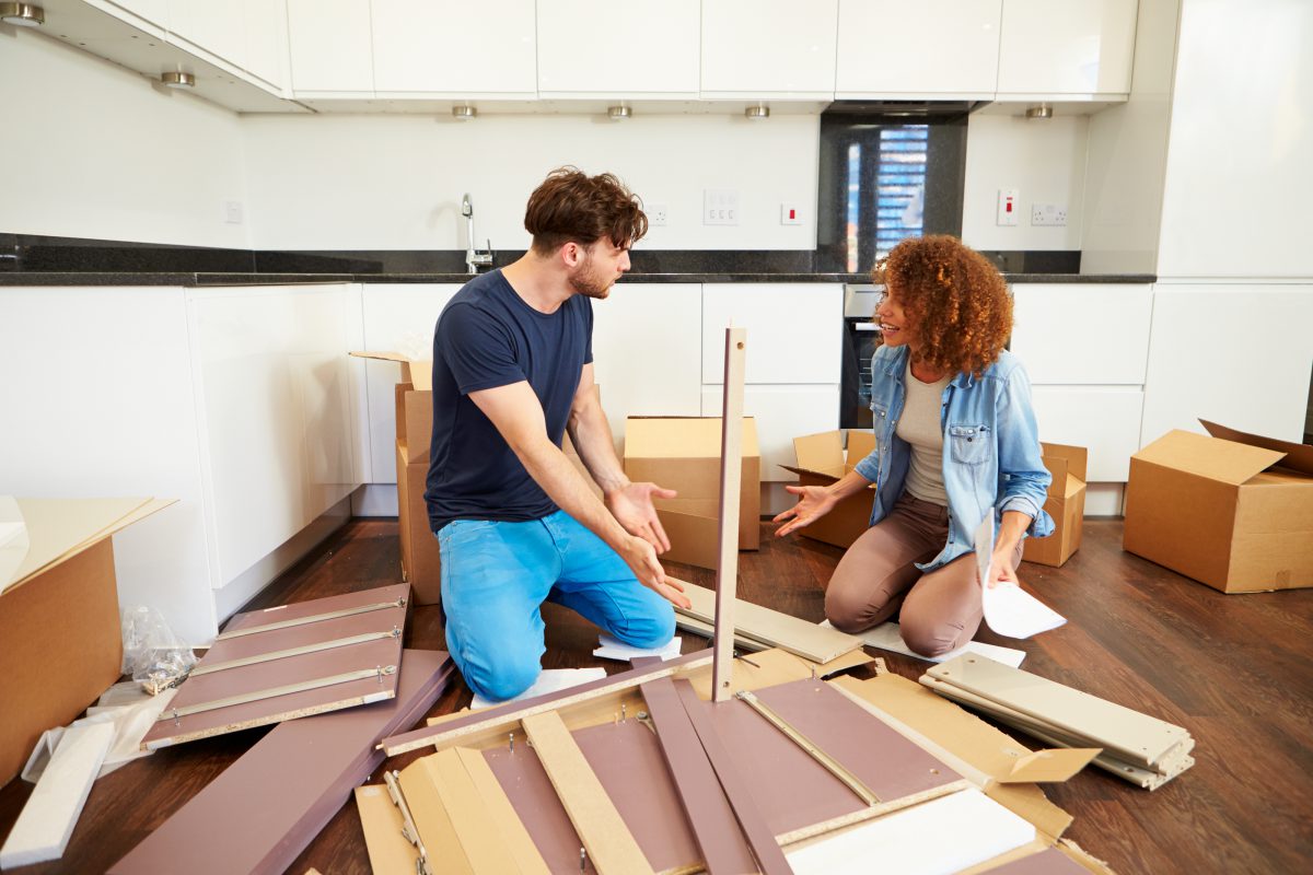 Couple assembling furniture together