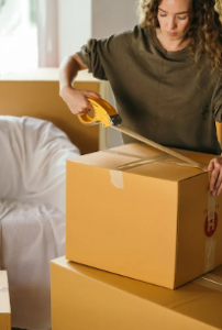 Woman packing box for moving