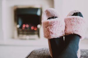 close up photography of person wearing pink house slippers